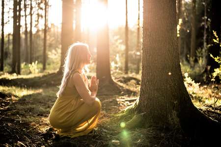 Une femme remercie l'esprit gardien de l'arbre